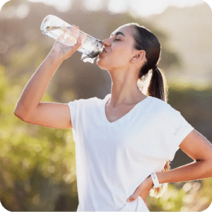 Sportliche Frau trinkt Wasser